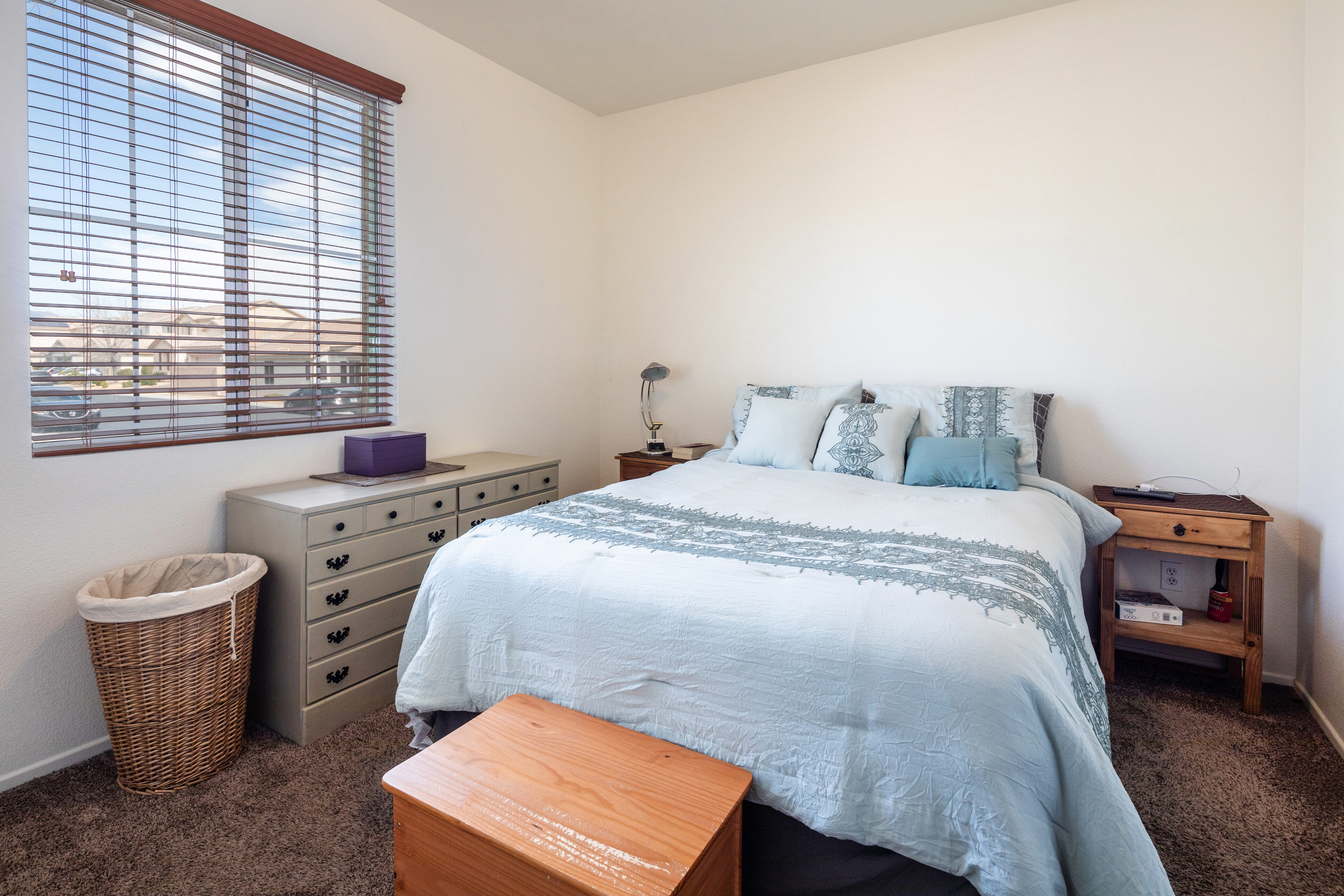 Large master bedroom with king bed and windows